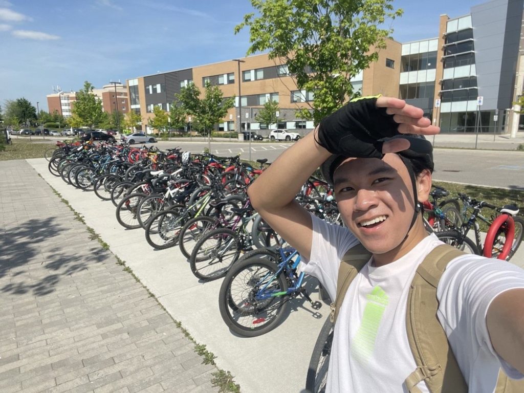 Brayden in front of full bike racks at his school