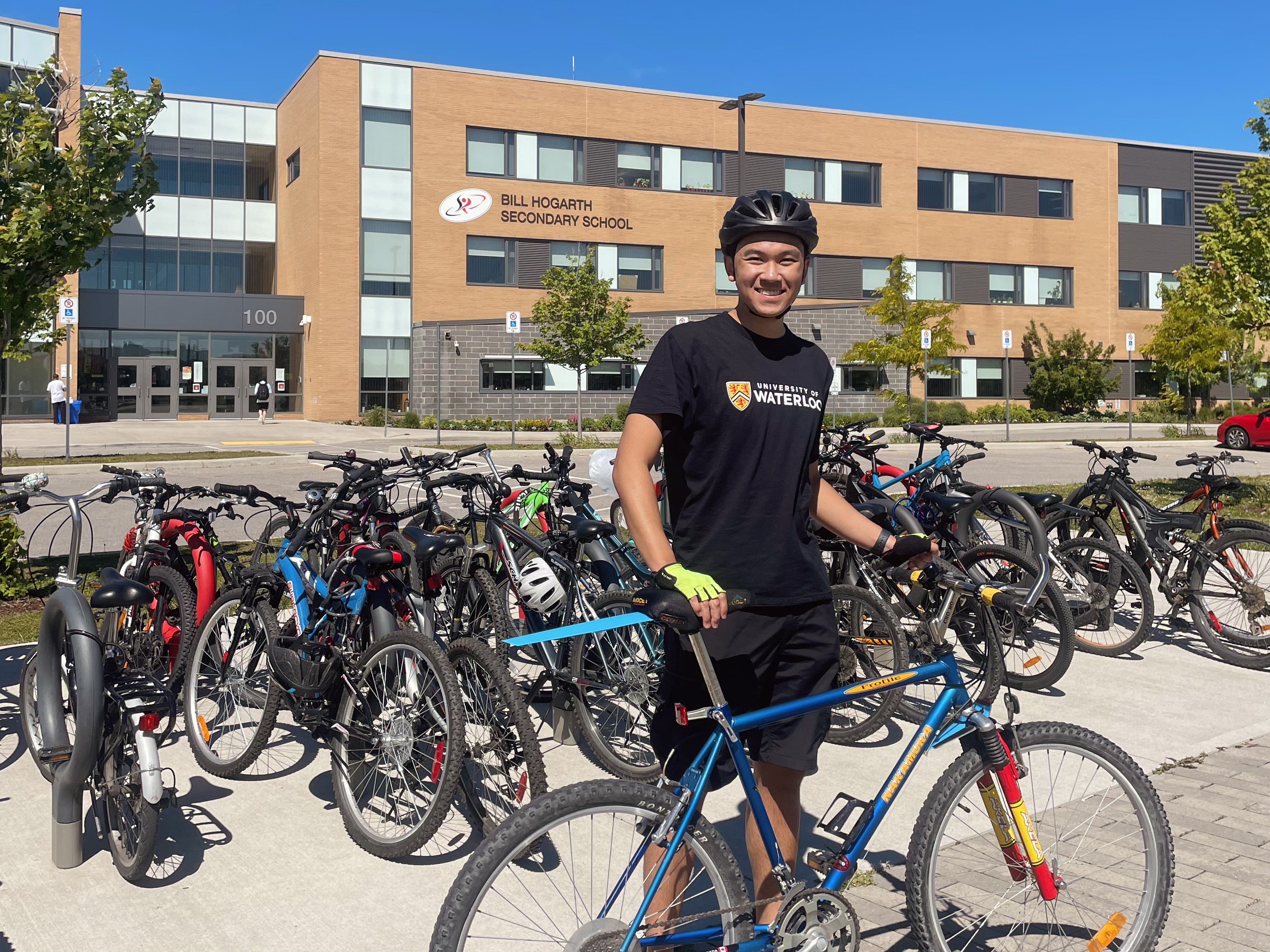 Braden Petersen in front of his school with his bike